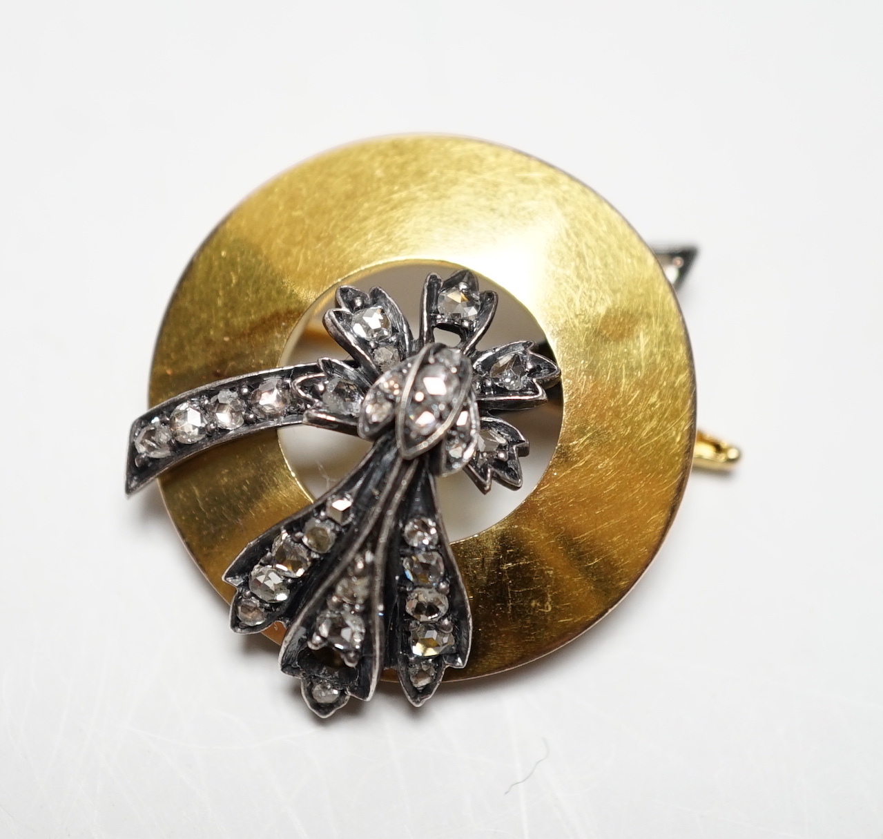 An early 20th century yellow metal and rose cut diamond cluster set circular brooch, 31mm, gross weight 10 grams.